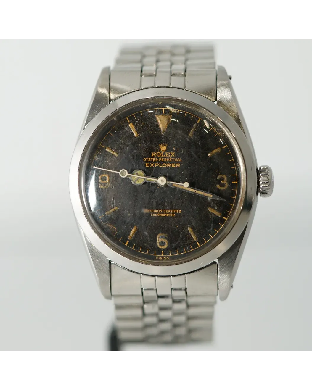 Dial detail of a Rolex Oyster Perpetual Explorer with aged black gilt dial and Jubilee bracelet.