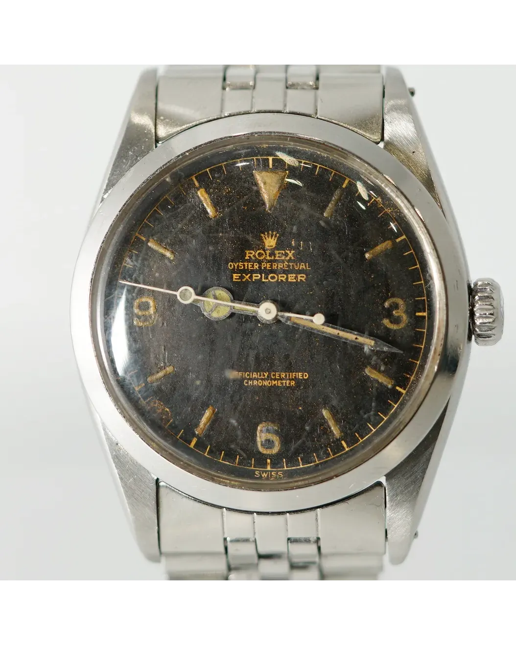 Dial detail of a Rolex Oyster Perpetual Explorer with tropical gilt dial, luminous Arabic numerals, and steel bracelet.