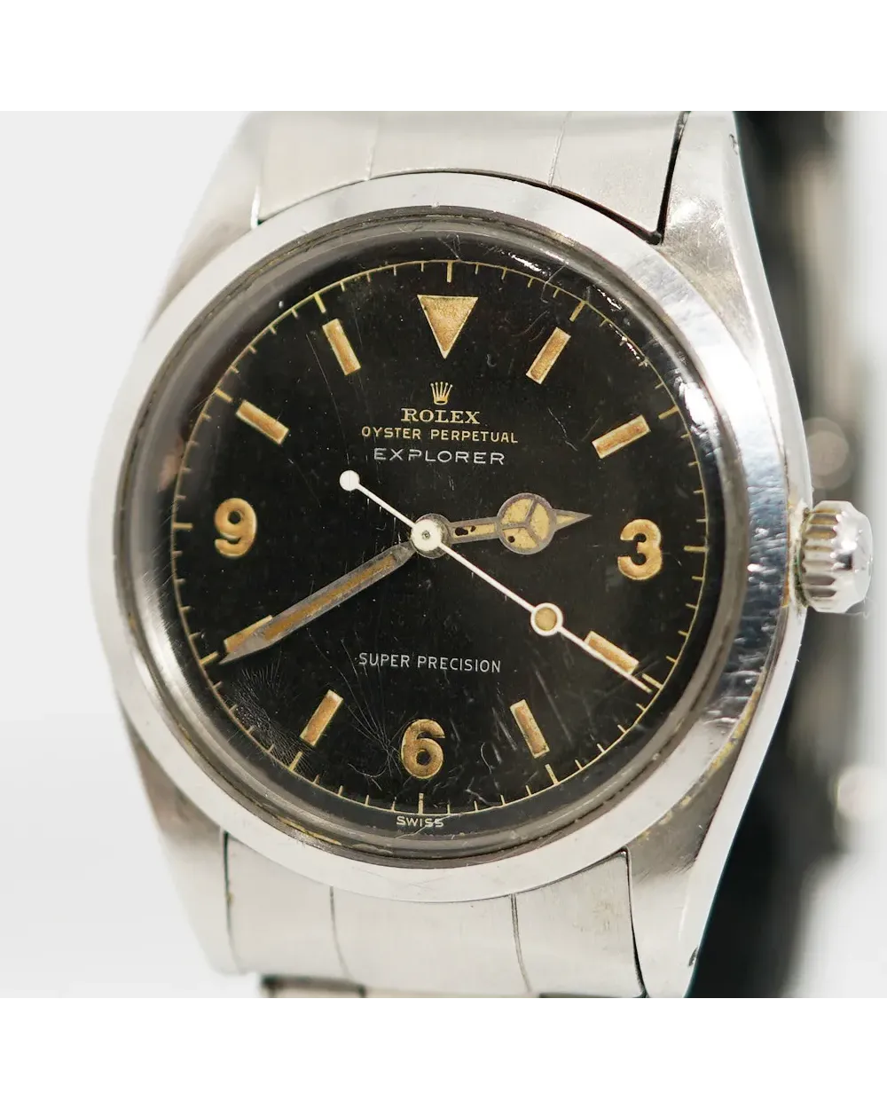 Dial detail of a Rolex Oyster Perpetual Explorer 5504 showing black gilt dial with tropical patina and aged luminous markers.