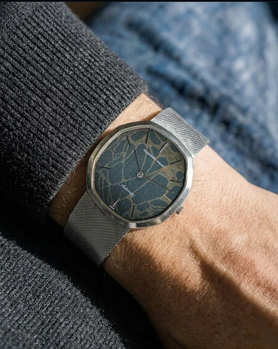 On the wrist shot of a Christian Paul watch with geometric patterned dial and mesh strap.