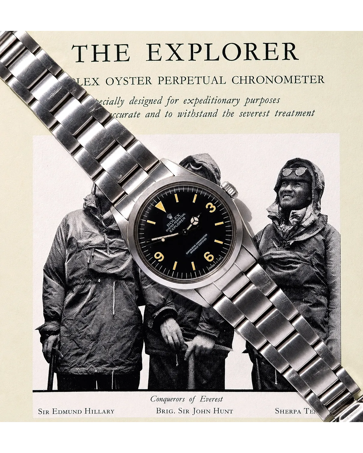 Flat-lay photograph of a Rolex Explorer with black dial, Arabic numerals, and Oyster bracelet against vintage Everest expedition imagery.