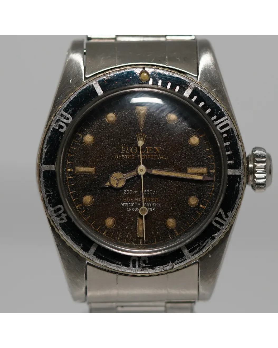 Dial detail of a Rolex Submariner 6538 small crown with tropical brown dial, gilt text, and patinated luminous markers.