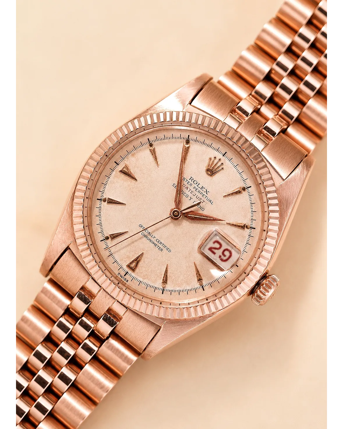 Dial detail of a rose gold Rolex Day-Date with fluted bezel, champagne dial, and date window showing 29.