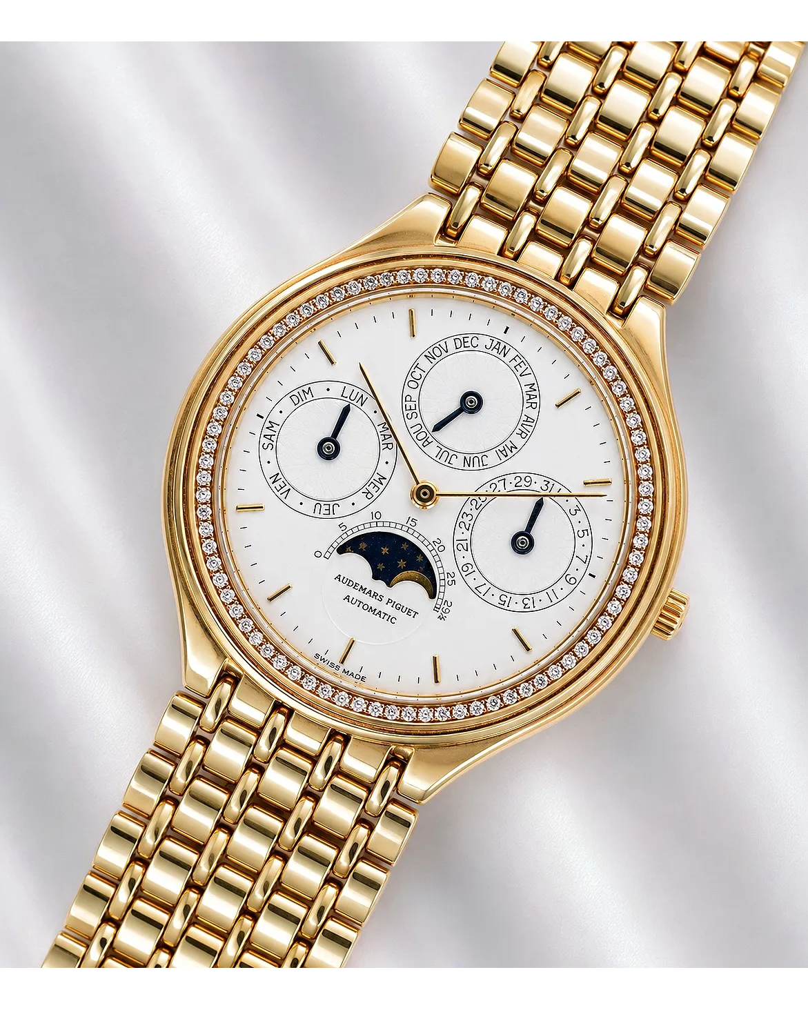 Dial detail of an Audemars Piguet perpetual calendar automatic in yellow gold with diamond-set bezel and moon phase complication.