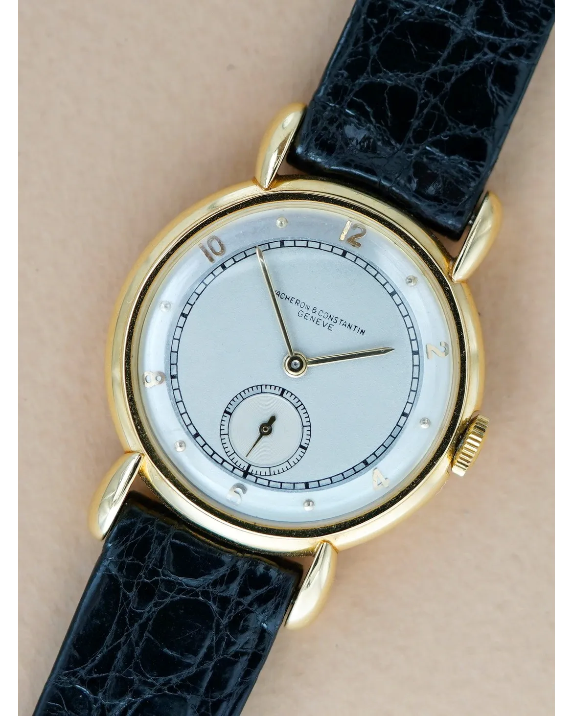 Dial detail of a Vacheron Constantin Genève displaying silvered dial, subsidiary seconds, applied numerals and black crocodile strap.