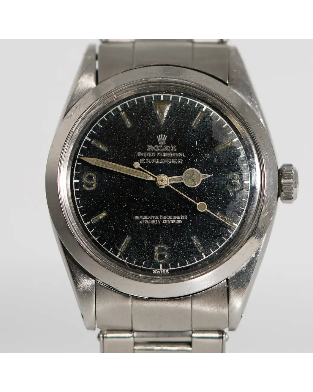 Dial detail of a Rolex Oyster Perpetual Explorer with tropical gilt dial, Mercedes hands, and Oyster bracelet.