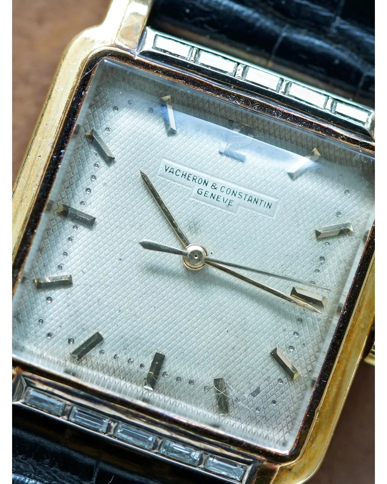 Dial detail of a Vacheron Constantin square case showing silver guilloche dial with baguette diamond bezel surround.